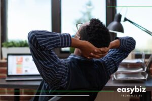 Employee relaxing at a desk after streamlining HR tasks with HR and Payroll Software South Africa